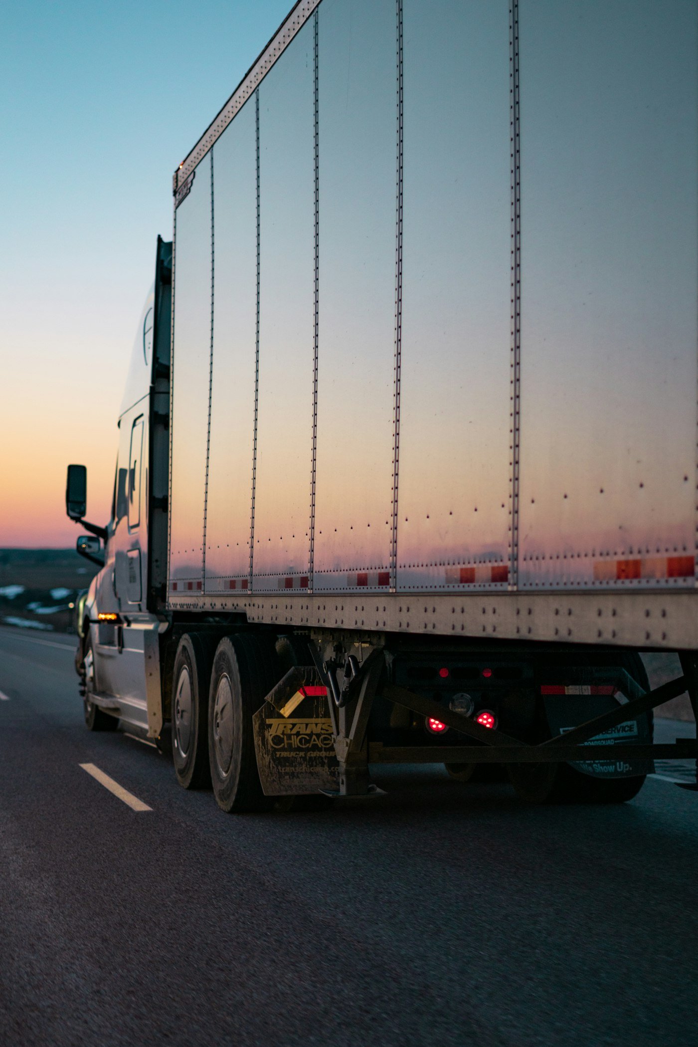 Tractor-trailer on the highway at dusk