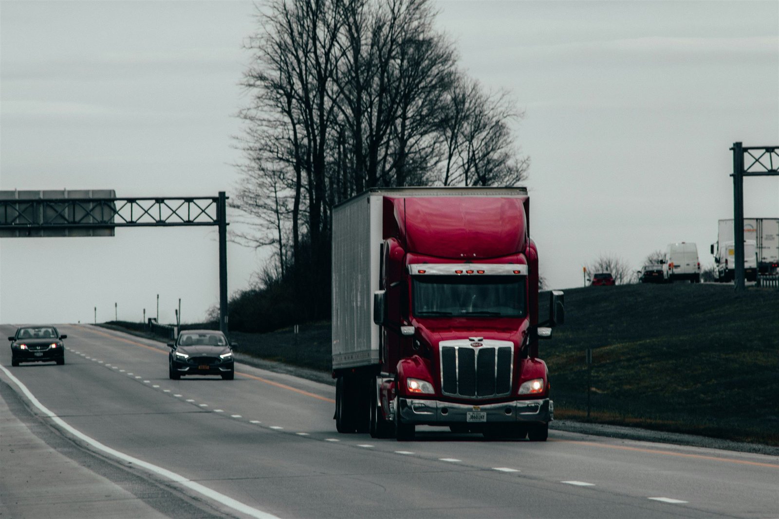 A tractor-trailer running on the interstate